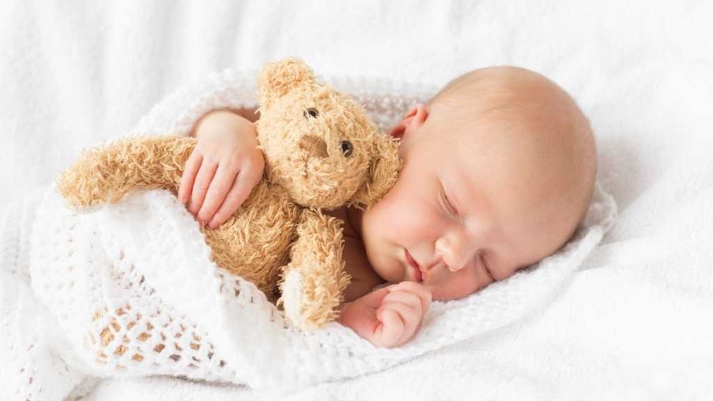 Babies love holding onto soft toys when they sleep.